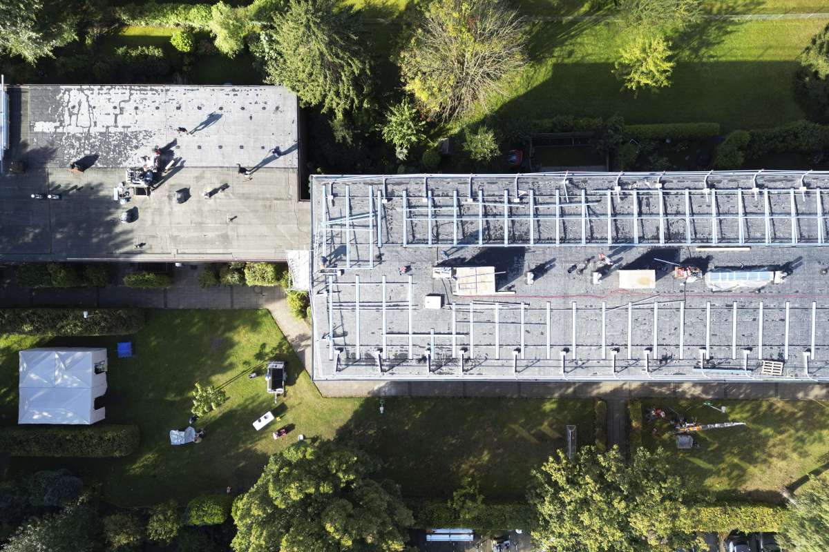 a building with a roof and trees